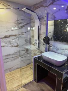 a bathroom with a sink and a shower at Candi Luxury Suites in Neos Marmaras