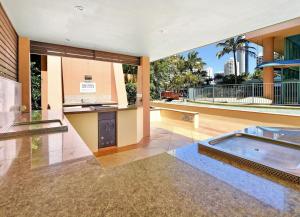 an empty house with a kitchen and a pool at Crown Towers Resort - Private 3 Bedroom Apartment in Gold Coast