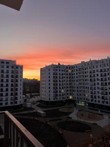 a view of a building with a sunset in the background at RentHouse Apartments Neoclassic in Chişinău