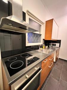 a kitchen with a stove and a sink at Feel like home Concert hall Apartment - Sem in Athens
