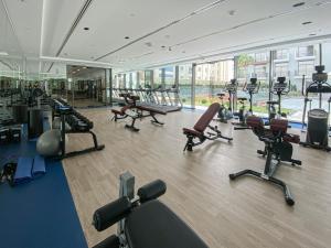 a gym with a bunch of exercise equipment in a room at Perfect Studio in Arjan in Dubai