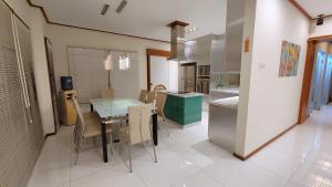 a kitchen with a table and chairs in a room at Japanese Style Villa at Dago Bandung 4BR Soo Maison in Bandung
