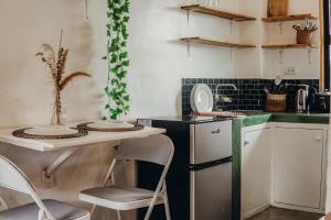 a kitchen with a table and chairs and a counter at Central Loft 2-3 mins away from Surf Spots in General Luna