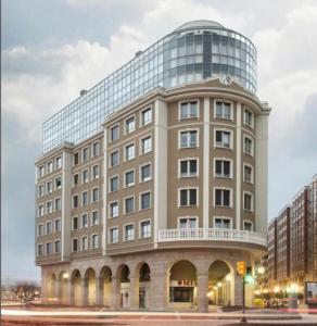 a large office building with a round window at Residencial Playa Poniente 66 de Gijón in Gijón
