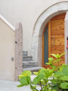 wejście do domu z drewnianymi drzwiami w obiekcie Casa Kaki w mieście Malcesine
