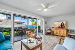 a living room with a view of the ocean at Casa De Emdeko 235 in Kailua-Kona