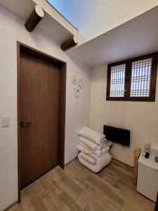 una habitación con puerta y un montón de toallas en Sungsim Hanok Guesthouse, en Jeonju