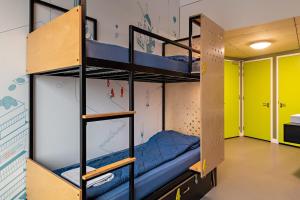 a room with bunk beds in a dorm room at Stayokay Hostel Utrecht Centrum in Utrecht