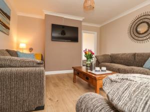 a living room with two couches and a coffee table at The Beach Huts in Hornsea