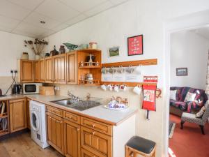 uma cozinha com um lavatório e uma bancada em Ty Hir em Llangoed