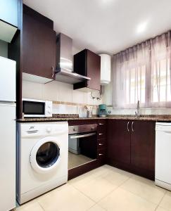 a kitchen with a washer and a dishwasher at Playa Dorada VISTAS al MEDITERRANEO in El Borseral