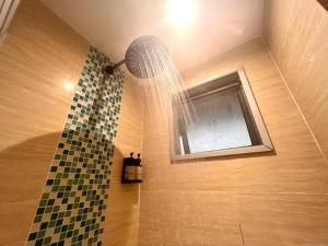 a shower with a shower curtain and a window at Reka Hotel Genting Highlands in Genting Highlands