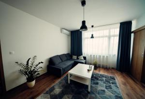 a living room with a couch and a table at TIFFANY Apartment Hotel in Bratislava