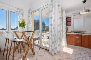 a kitchen and dining room with a table and chairs at Two-bedroom apartment NIKI near Rovinj in Rovinj