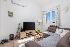 a living room with a couch and a flat screen tv at Two-bedroom apartment NIKI near Rovinj in Rovinj