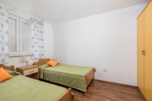 a small room with two beds and a window at Two-bedroom apartment NIKI near Rovinj in Rovinj