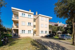 an apartment building with cars parked in front of it at Two-bedroom apartment NIKI near Rovinj in Rovinj