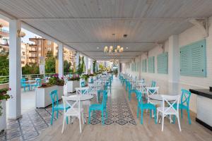 a row of tables and chairs on a patio at Euphoria Comfort Beach Alanya in Mahmutlar