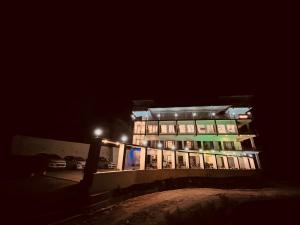 a building at night with a parking lot in front of it at The Kempty Fall Resort, Mussoorie in Mussoorie