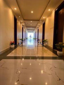 a hallway of a building with a person in the distance at The Kempty Fall Resort, Mussoorie in Mussoorie