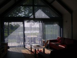 a living room with a large window with curtains at Ottenskamp4 in Siebengewald