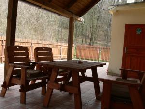 a wooden table and two chairs on a patio at Salas-Partizanske in Partizánske