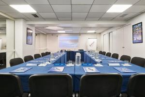 a conference room with a long table and chairs at Campanile Hotel Nice Centre Acropolis in Nice