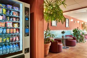 un distributore automatico di bevande in un ristorante con tavolo di Campanile Hotel Nice Centre Acropolis a Nizza