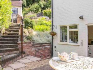 a table with a tea set on top of it at Charming 1-Bed Cottage located in Ironbridge in Ironbridge
