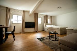 a living room with a couch and a bed at Oldtown Studio Apartment with 2 Bathrooms in Düsseldorf