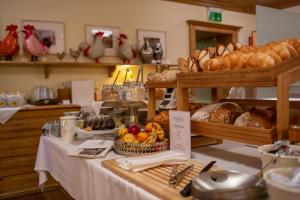 a table with bread and pastries and other food items at Hotel & Restaurant Stern in Gmünd