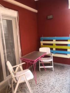 a table and chairs in a room with a colorful wall at Two bedroom apartment in Historical area in Thessaloniki