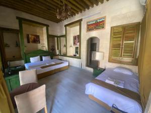 a bedroom with two beds and a table and chairs at HANEHAN in Sanlıurfa
