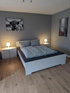 a bedroom with a bed with two night stands and two lamps at Flensburg Zentrum 69 01 in Flensburg