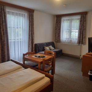 a hotel room with a bed and a table at Gasthof Kögerlwirt in Göstling an der Ybbs