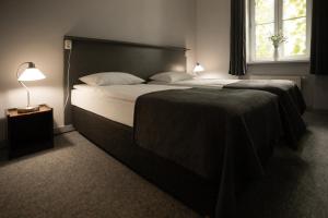 a bedroom with a large bed and a window at Apartament Satynowy by Good Time in Łódź