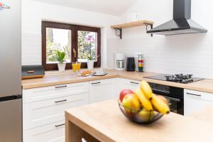 a kitchen with a bowl of fruit on a counter at Apartment Gac in Cavtat