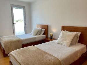 En eller flere senge i et værelse på Ocean Terrace House