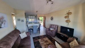 a living room with a couch and chairs and a kitchen at Laguna La Crete 225 in Margate