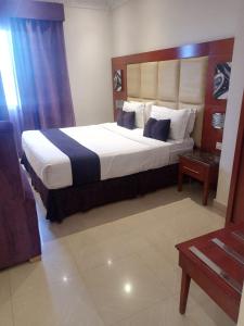 a bedroom with a large bed in a room at Nawara HAYER in Riyadh