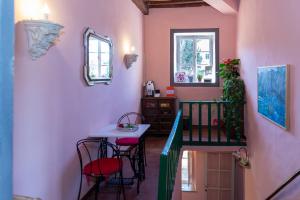 a room with a table and chairs and a stairway at NEW! La Stanza in Villa in Lucca