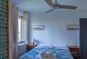 a bedroom with a bed and a ceiling fan at NEW! La Stanza in Villa in Lucca