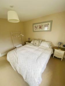 a bedroom with a large white bed in it at The Willow Studio - peaceful retreat near Whitstable seaside in Kent