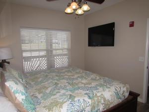 a bedroom with a bed and a tv and a window at Walk-in Condo A-4 in Hollister