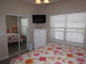 a bedroom with a bed and a tv and a mirror at Walk-in Condo A-4 in Hollister