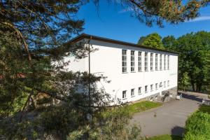 a white building with a lot of windows at Sportschule Werdau in Werdau