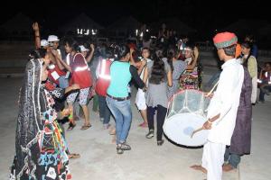 a group of people dancing on the beach at Golden Fort Resort in Jaisalmer