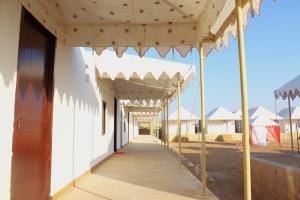 a white building with awnings on a sidewalk at Golden Fort Resort in Jaisalmer