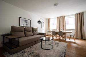 a living room with a couch and a table at Old Town Apartment 2 rooms/baths in Düsseldorf