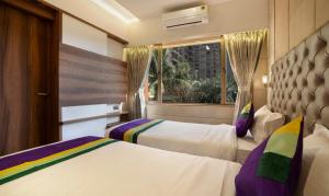 Katil atau katil-katil dalam bilik di Treebo Premium Savera Inn